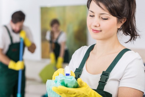 Cleaner wearing PPE while operating professional carpet cleaning equipment